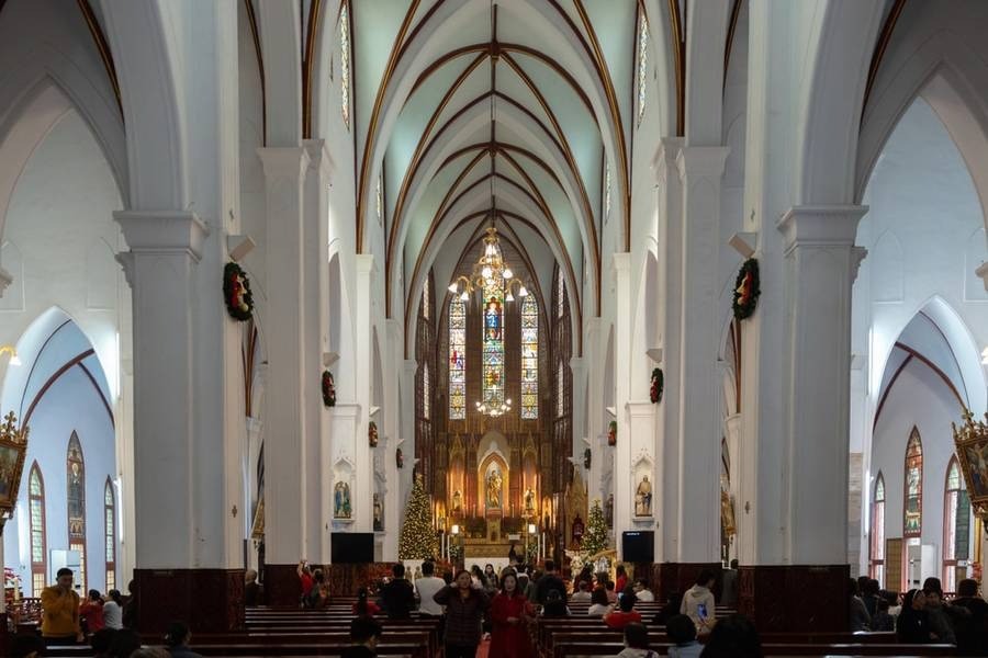 Attending mass in St. Joseph's Cathedral Hanoi Vietnam (Source: Traveloka)